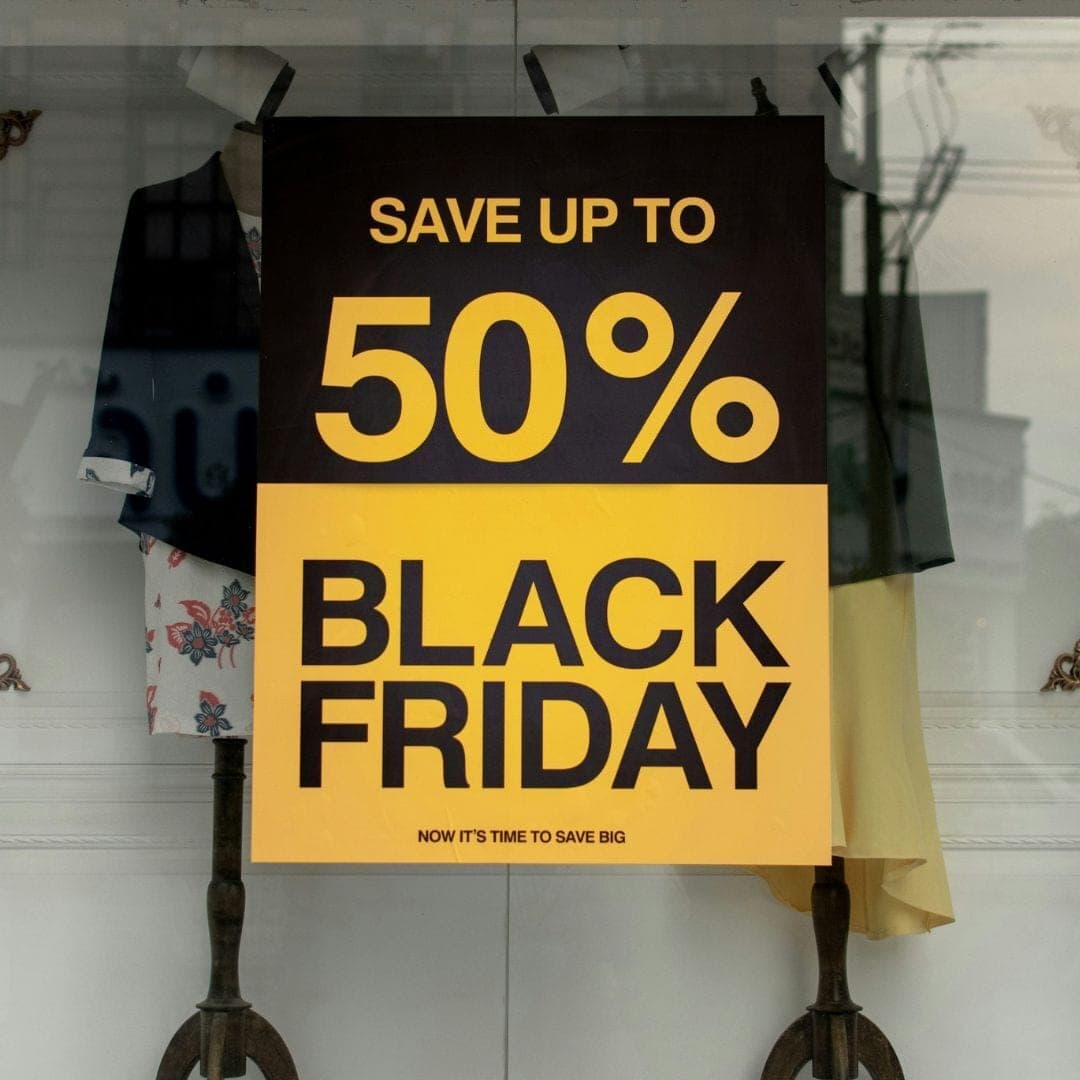 Shop window poster reading Save up to 50% Black Friday