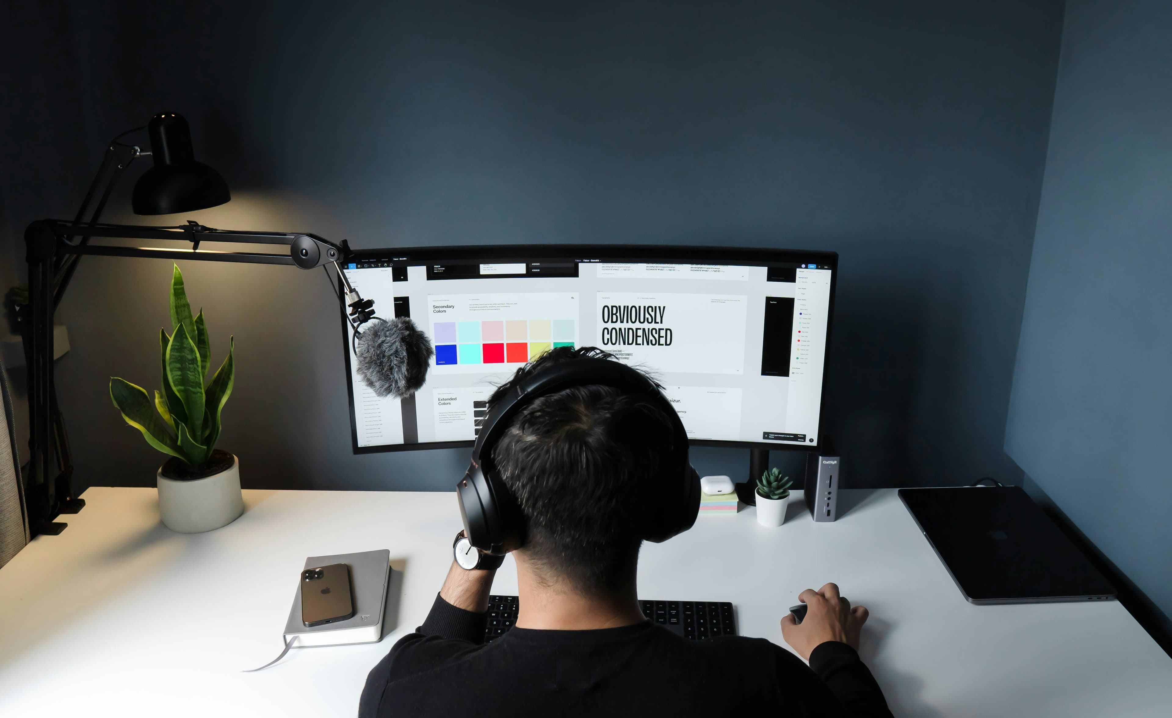 Person sitting at desk building a website on computer.