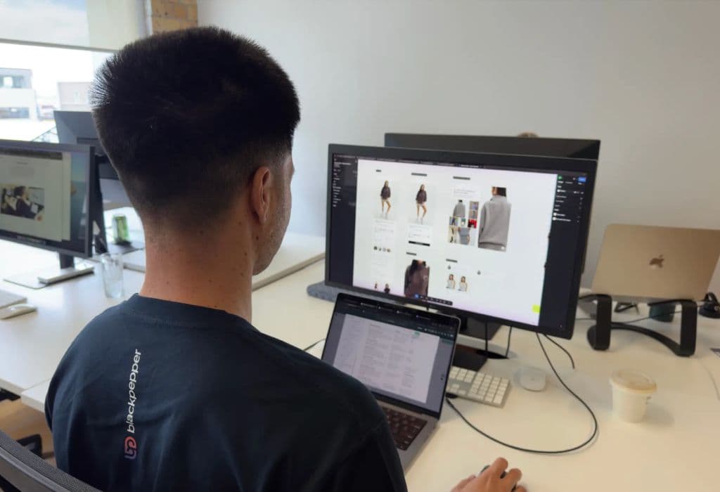Person sitting at desk building a website.
